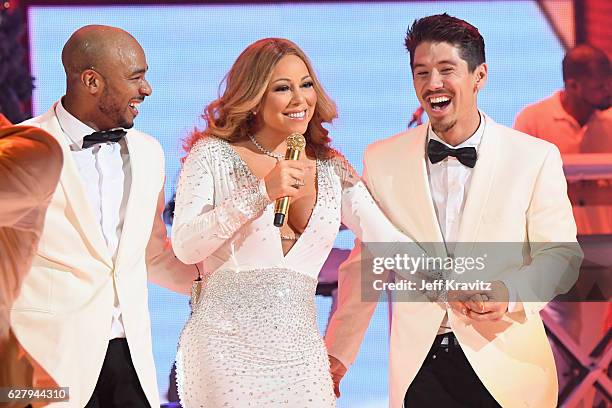 Mariah Carey and dancers Anthony Burrell and Bryan Tanaka perform during the opening show of Mariah Carey: All I Want For Christmas Is You at Beacon...