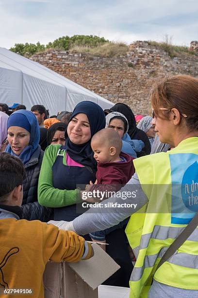 breakfast line in souda refugee camp on chios - quiosque stock pictures, royalty-free photos & images