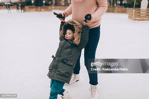 learning to ice-skate - family ice skate stock pictures, royalty-free photos & images
