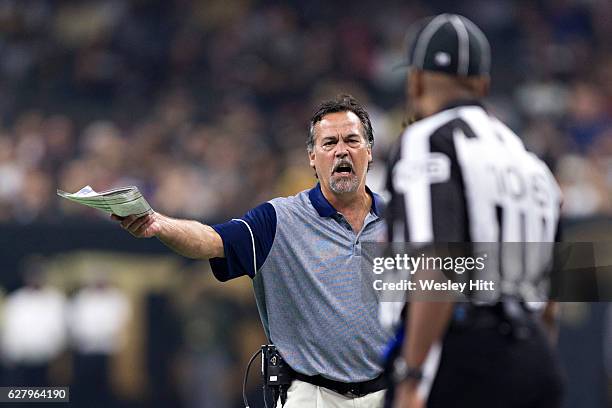 Head Coach Jeff Fisher of the Los Angeles Rams talks with a official during a game against the New Orleans Saints at Mercedes-Benz Superdome on...