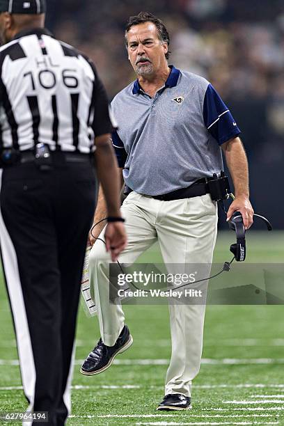 Head Coach Jeff Fisher of the Los Angeles Rams talks with a official during a game against the New Orleans Saints at Mercedes-Benz Superdome on...