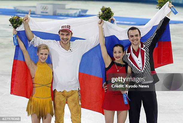 Russia - Russia's Tatiana Volosozhar and Maxim Trankov celebrate with compatriots Ksenia Stolbova and Fedor Klimov after winning the Winter Olympics...