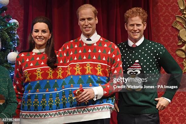 Wax figures of members of the Royal family, from left, the Duchess of Cambridge, the Duke of Cambridge and Prince Harry, wear their Christmas jumpers...