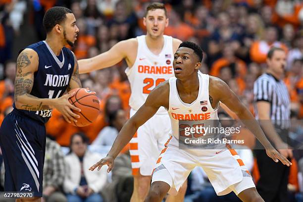 Tyus Battle of the Syracuse Orange defends Dallas Moore of the North Florida Ospreys as Tyler Lydon of the Syracuse Orange looks on a during the...