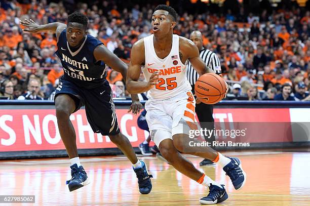 Tyus Battle of the Syracuse Orange drives to the basket past Nick Malonga of the North Florida Ospreys during the second half at the Carrier Dome on...