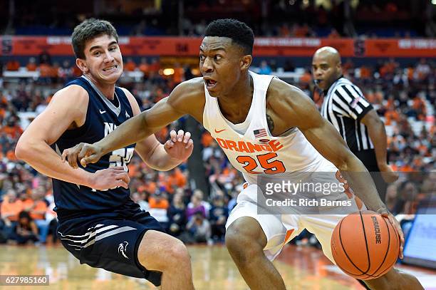 Tyus Battle of the Syracuse Orange drives to the basket past Benedikt Haid of the North Florida Ospreys during the second half at the Carrier Dome on...