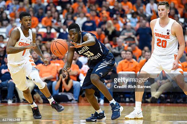 Nick Malonga of the North Florida Ospreys reaches for a loose ball between Frank Howard and Tyler Lydon of the Syracuse Orange during the second half...