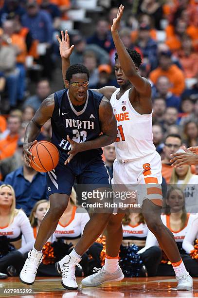 Romelo Banks of the North Florida Ospreys drives to the basket as Tyler Roberson of the Syracuse Orange defends during the second half at the Carrier...