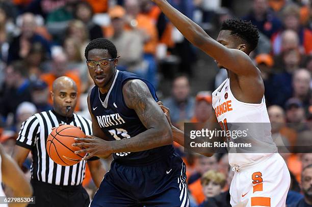 Romelo Banks of the North Florida Ospreys controls the ball as Tyler Roberson of the Syracuse Orange defends during the second half at the Carrier...