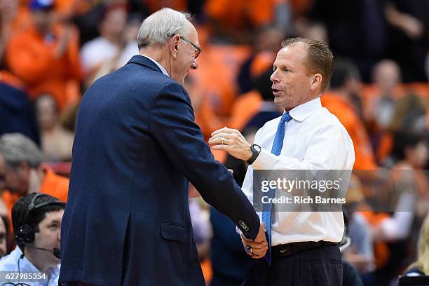 Head coach Jim Boeheim of the Syracuse Orange and head coach Matthew Driscoll of the North Florida Ospreys shake hands following the game at the...