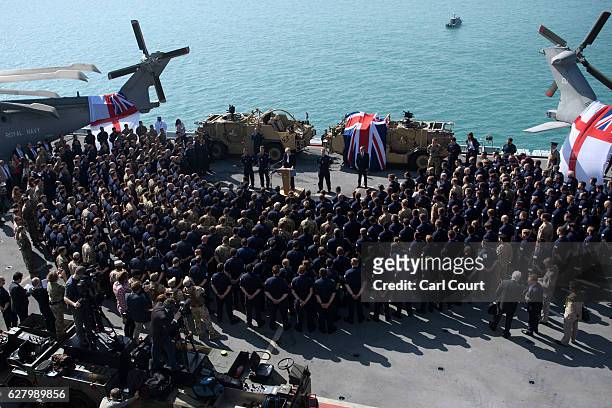 British Prime Minister Theresa May addresses sailors on board HMS Ocean during her trip to attend the Gulf Cooperation Council summit in Bahrain, on...