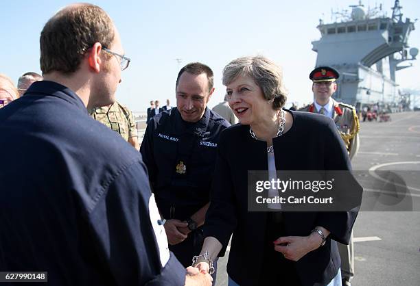 British Prime Minister Theresa May meets sailors during a visit to HMS Ocean while in Bahrain to attend the Gulf Cooperation Council summit in...