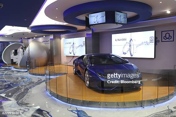 Blue Lamborghini automobile, manufactured by Automobili Lamborghini SpA, sits on display inside the Al Rajhi Bank as customers use automated teller...