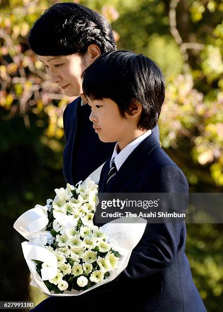 Princess Kiko of Akishino and her son Prince Hisahito offer flowers at the A-bomb Hypocenter Memorial at Nagasaki Hypocenter Park on December 6, 2016...