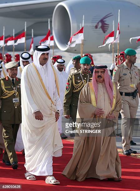 King of Bahrain, Hamad bin Issa al-Khalifa welcomes the Emir of Qatar Sheikh Tamim bin Hamad al-Thani upon his arrival for the 37th Gulf Cooperation...