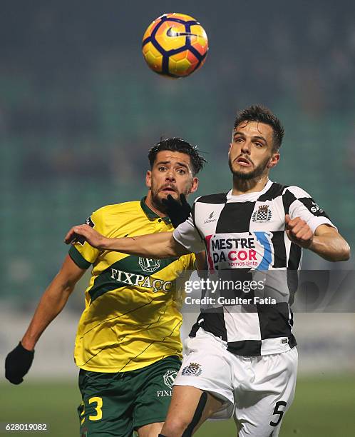 Boavista FC's defender Talocha with Pacos Ferreira's forward Ivo Rodrigues from Portugal in action during the Primeira Liga match between Pacos de...