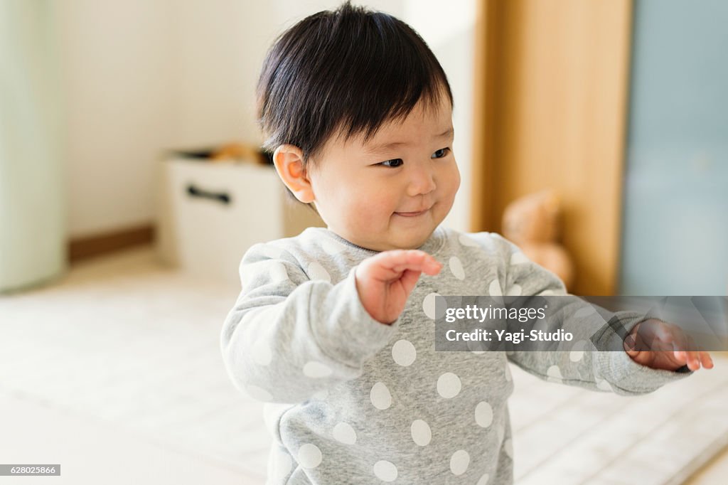 Cute baby girl playing in home