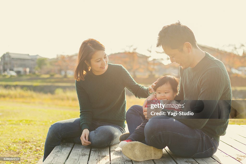 Happy family having a good time with baby girl