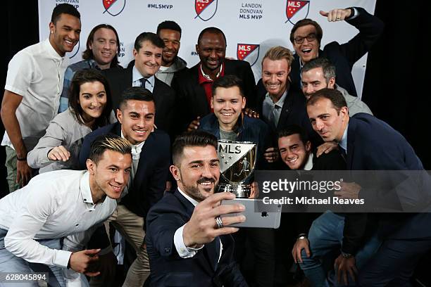 David Villa of New York City FC takes a photo with his New York City FC teammates after being presented with the 2016 Landon Donovan MLS MVP trophy...