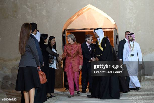 British Prime Minister Theresa May meets attendees as she arrives for a young leaders reception at Riffa Fort while in Bahrain to attend the Gulf...
