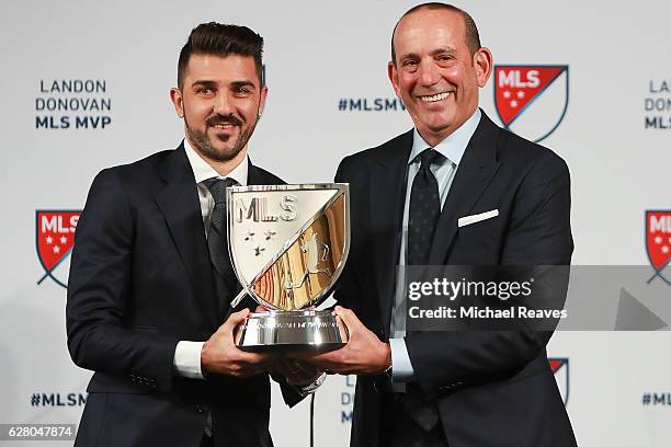 Commissioner Don Garber presents the 2016 Landon Donovan MLS MVP trophy to David Villa of New York City FC at Spring Studios on December 6, 2016 in...