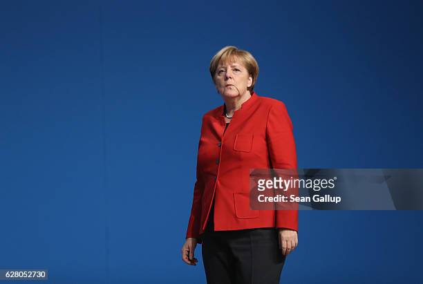 German Chancellor and Chairwoman of the German Christian Democrats Angela Merkel walks after she was re-elected with 89.5% of the vote, one of her...