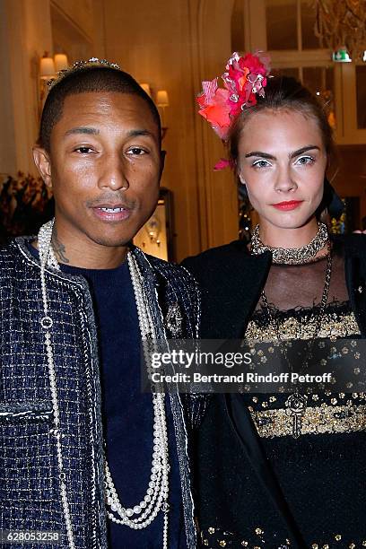 Pharrell Williams and Cara Delevingne attend the "Chanel Collection des Metiers d'Art 2016/17 : Paris Cosmopolite" : Show at Hotel Ritz on December...