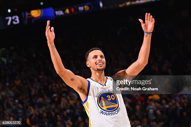 Stephen Curry of the Golden State Warriors smiles and gets the crowd into the game against the Indiana Pacers on December 5, 2016 at ORACLE Arena in...