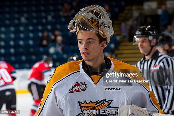 Jordan Papirny of the Brandon Wheat Kings stands at the bench during warm up against the Kelowna Rockets on December 3, 2016 at Prospera Place in...