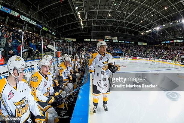 Jordan Wharrie of the Brandon Wheat Kings stands on the ice at the bench during a time out against the Kelowna Rockets on December 3, 2016 at...