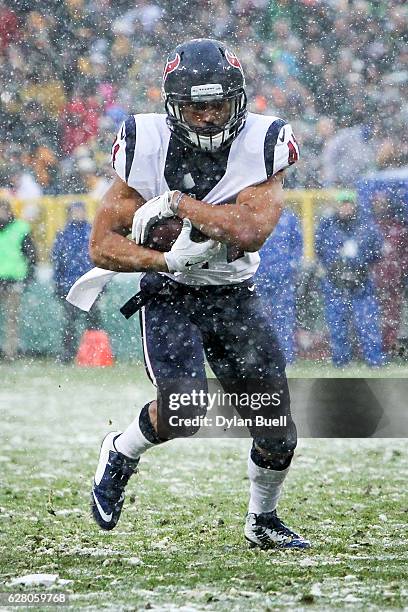 Jonathan Grimes of the Houston Texans runs with the ball in the third quarter against the Green Bay Packers at Lambeau Field on December 4, 2016 in...