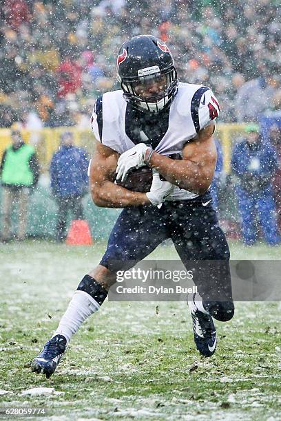 Jonathan Grimes of the Houston Texans runs with the ball in the third quarter against the Green Bay Packers at Lambeau Field on December 4, 2016 in...