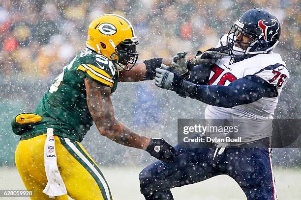 Julius Peppers of the Green Bay Packers battles against Duane Brown of the Houston Texans in the fourth quarter at Lambeau Field on December 4, 2016...