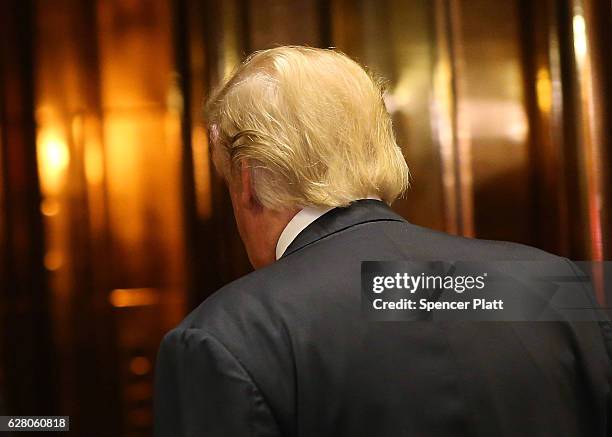 President-Elect Donald Trump walks back into an elevator after emerging for a minute to speak to the media at Trump Tower following meetings on...