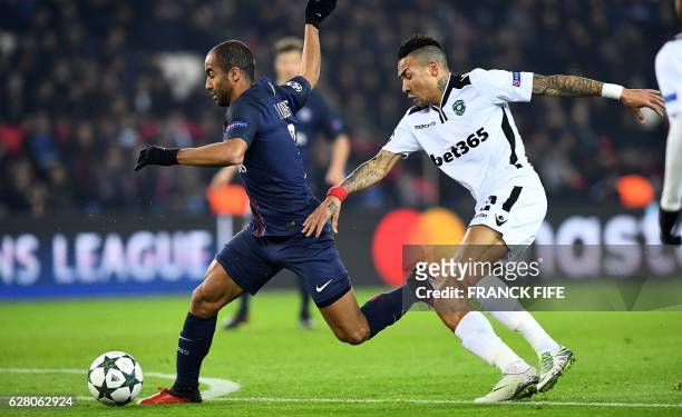 Paris Saint-Germain's Brazilian midfielder Lucas Moura vies for the ball with Ludogorets' Madagascan midfielder Anicet Abel during the UEFA Champions...