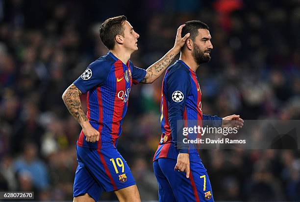 Arda Turan of Barcelona celebrates with Lucas Digne as he scores their second goal during the UEFA Champions League Group C match between FC...