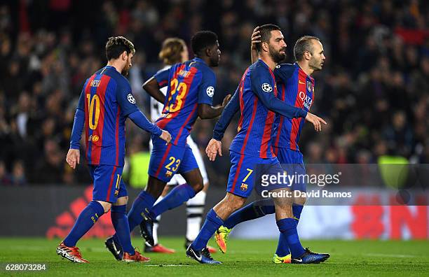 Arda Turan of Barcelona celebrates with Andres Iniesta as he scores their second goal during the UEFA Champions League Group C match between FC...