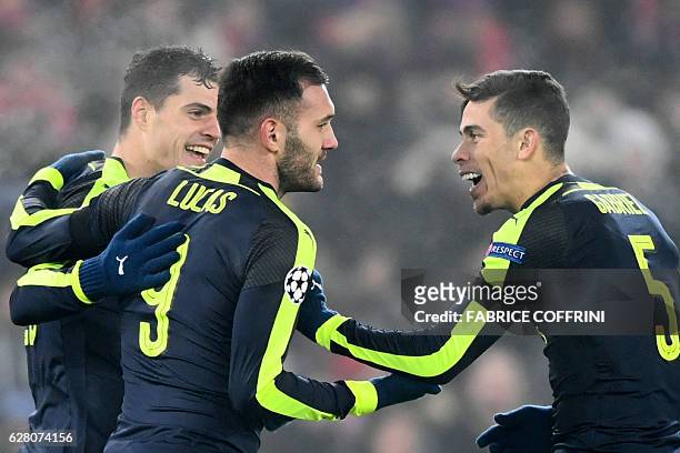 Arsenal's Spanish forward Lucas Perez celebrates after scoring a goal with his teammate Arsenal's Brazilian defender Gabriel during the UEFA...