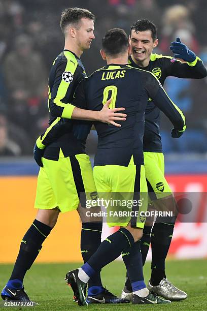 Arsenal's Spanish forward Lucas Perez celebrates after scoring a goal with his teammates during the UEFA Champions league Group A football match...