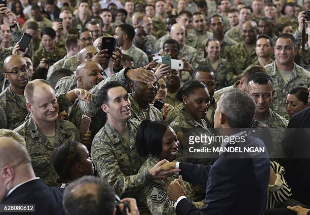 President Barack Obama greets service members after speaking on counterterrorism at MacDill Air Force Base in Tampa, Florida on December 6, 2016. /...