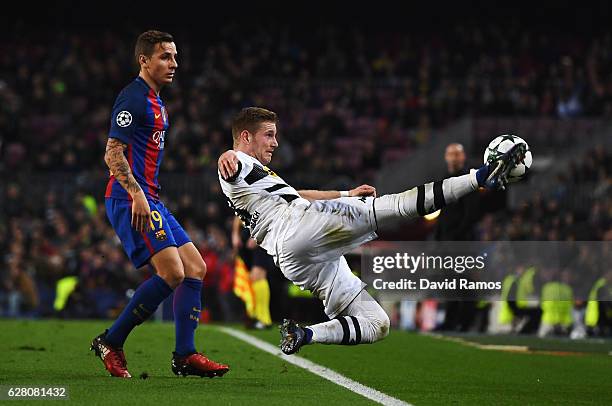 Erik Sviatchenko of Celtic attempts to keep the ball in while Lucas Digne of Barcelona looks on during the UEFA Champions League Group C match...