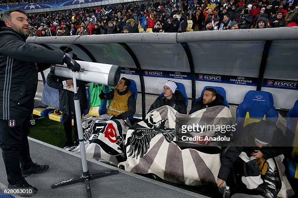 Football players of Besiktas warm themselve by heater during to the UEFA Champions league football match between Dinamo Kiev and Besiktas at the...