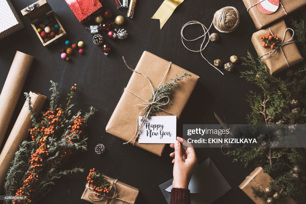 Wrapping New Year gifts, table top flat lay