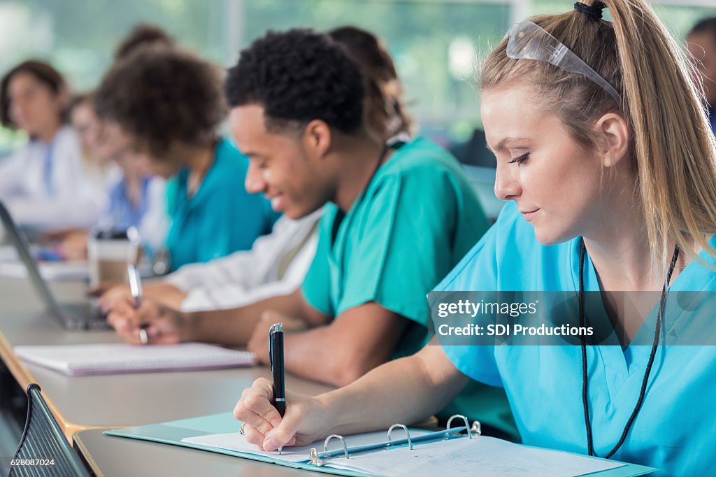 Focus medical students take notes during lecture
