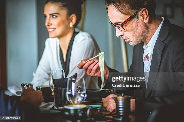 couple enjoys lunch time at asian restaurant. - eating secret stockfoto's en -beelden