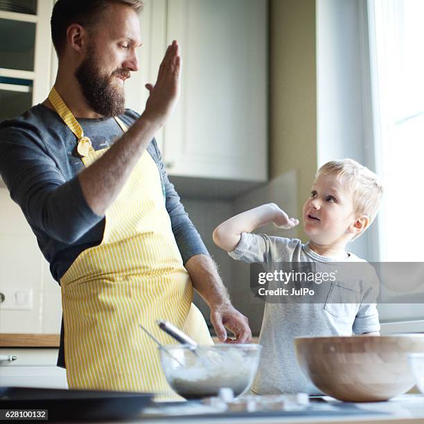 father cooking with his son - single father stock pictures, royalty-free photos & images