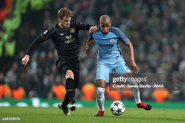 Stuart Armstrong of Celtic competes with Fernando of Manchester City during the UEFA Champions League match between Manchester City FC and Celtic FC...