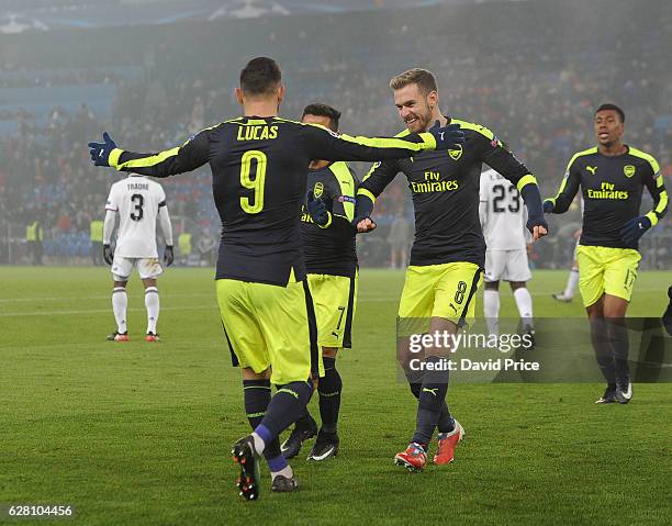 Lucas Perez celebrates scoring his and Arsenal's 3rd goal with Aaron Ramsey during the UEFA Champions League match between FC Basel and Arsenal at...