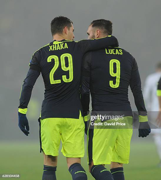 Lucas Perez celebrates scoring his and Arsenal's 3rd goal with Granit Xhaka during the UEFA Champions League match between FC Basel and Arsenal at...