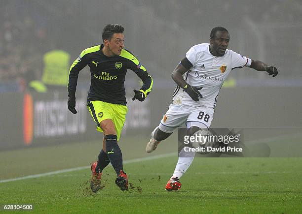 Mesut Ozil of Arsenal under pressure from Seydou Doumbia of Basel during the UEFA Champions League match between FC Basel and Arsenal at St....